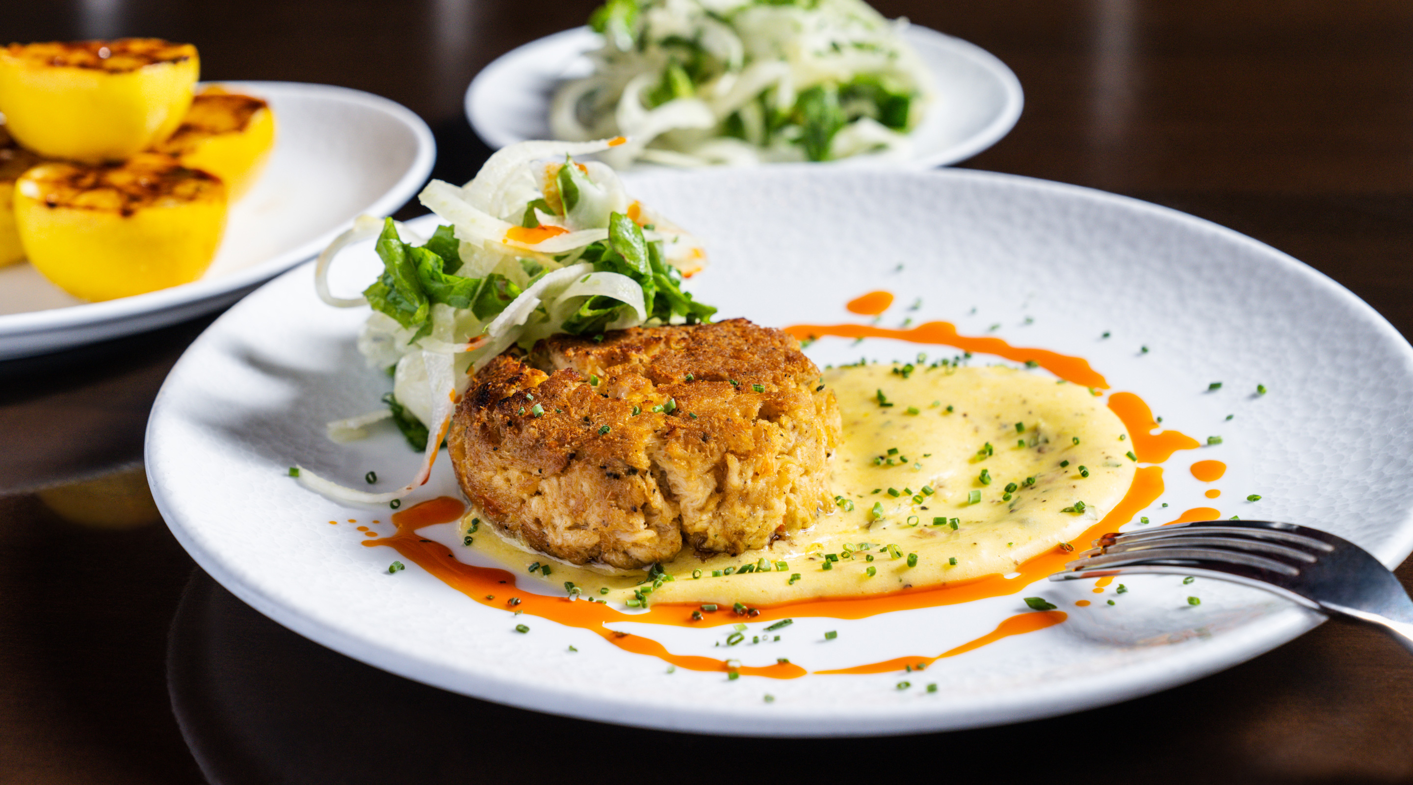 Cajun-spiced crab cakes with lemon caper aioli, and fennel salad.