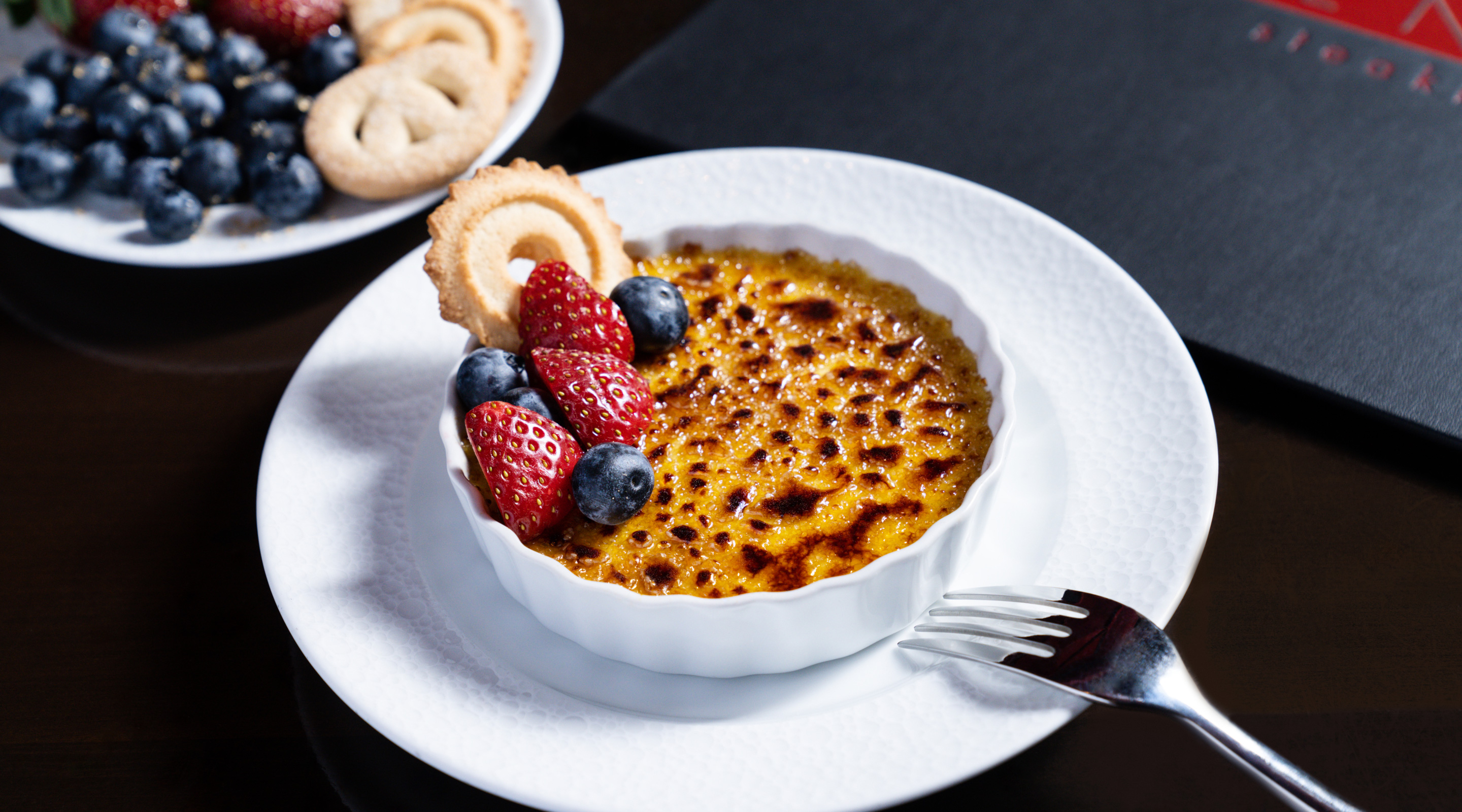 Creme brulee with raspberries and blueberries.