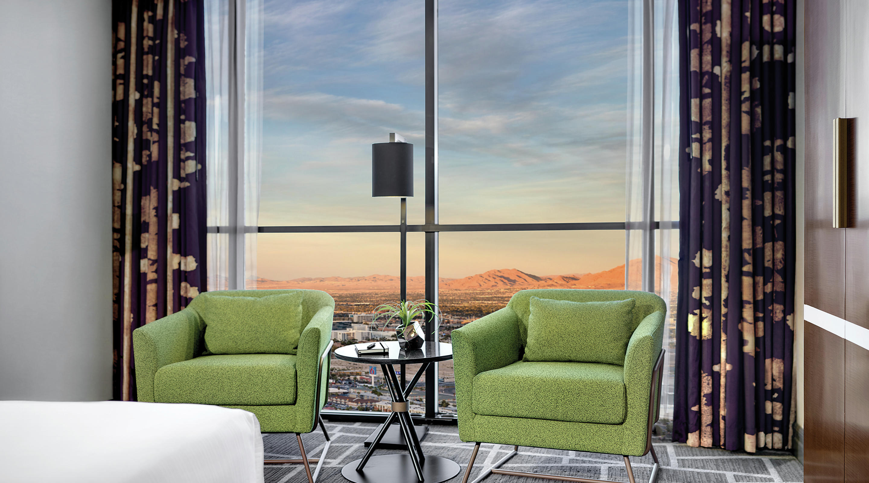 Two chairs in living area with a mountain view in a Tower Premium King Room.